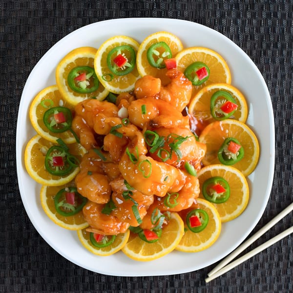 Dragon Dynasty Take Out's orange chicken, garnished with orange slices, jalapeños, and green onions.